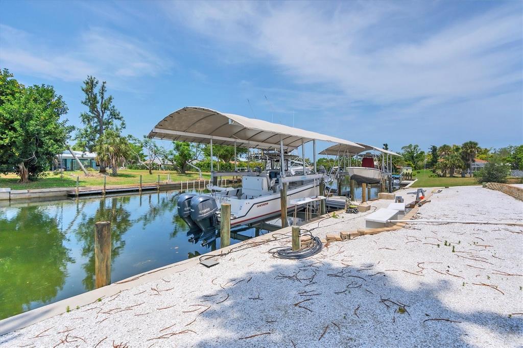 245 Spaniards Road Placida, FL 33946 - Photo 16 of 65 a view of a lake with a terrace