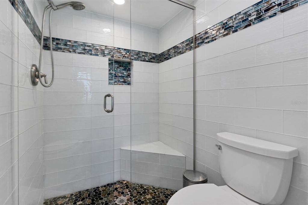 245 Spaniards Road Placida, FL 33946 - Photo 30 of 65 a bathroom with a shower a toilet and a window