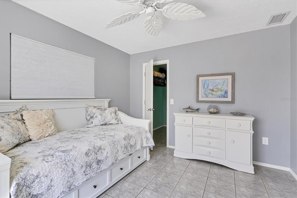 245 Spaniards Road Placida, FL 33946 - Photo 32 of 65 a bedroom with a bed and a chandelier