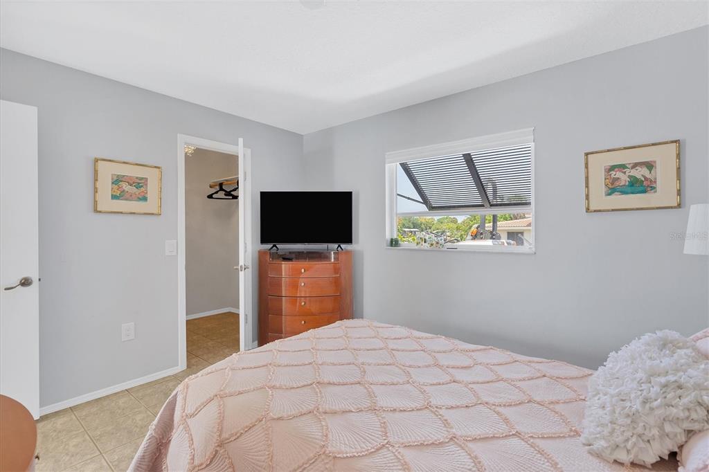 245 Spaniards Road Placida, FL 33946 - Photo 37 of 65 a bedroom with a bed and a flat screen tv