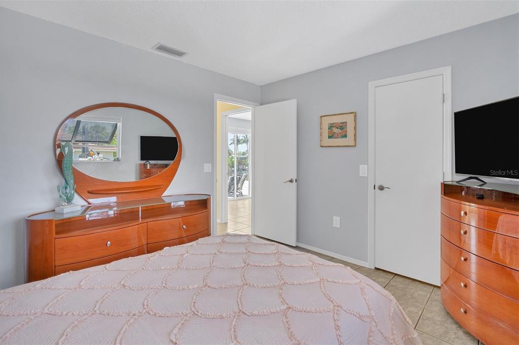 245 Spaniards Road Placida, FL 33946 - Photo 38 of 65 a bedroom with a bed and a flat screen tv