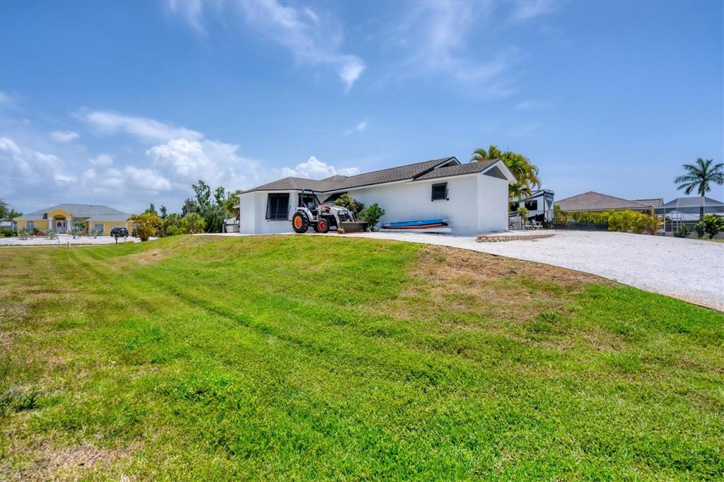 245 Spaniards Road Placida, FL 33946 - Photo 48 of 65 a front view of a house with a yard and garage