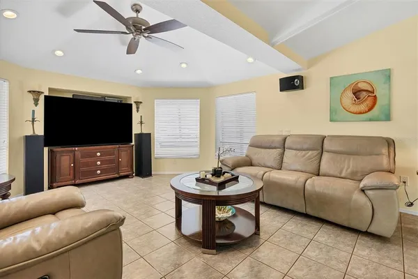 a living room with furniture and a view of bedroom