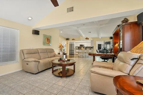 a living room with furniture and a floor to ceiling window