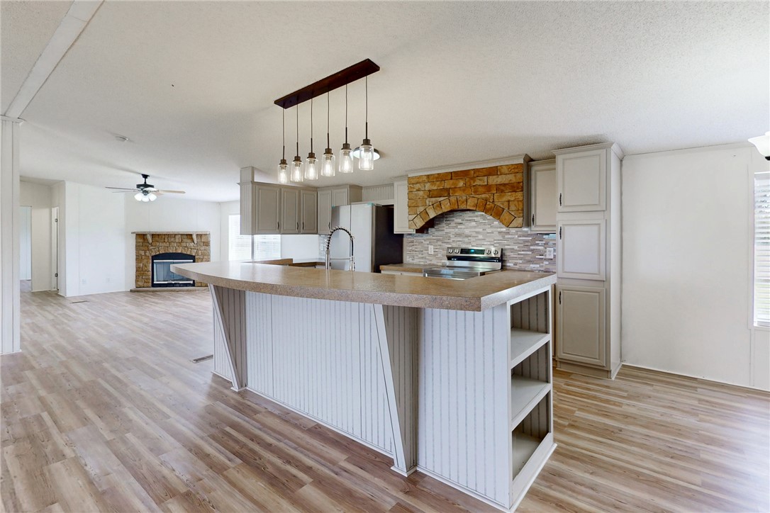 11459 Winstead Lane Calvert, TX 77837 - Photo 4 of 37 a kitchen with kitchen island a stove a sink and a refrigerator