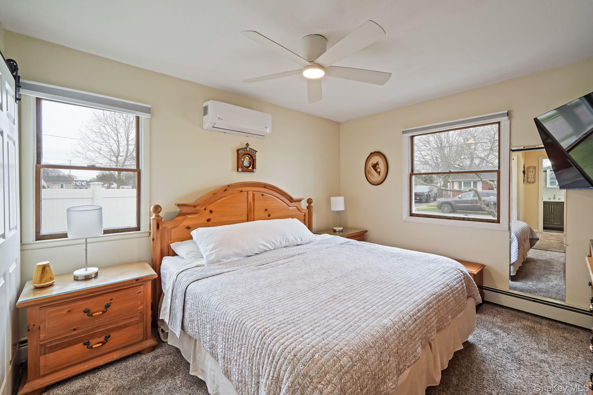 11 Nehring Avenue Babylon, NY 11702 - Photo 12 of 27 a bedroom with a bed and a window with the dresser