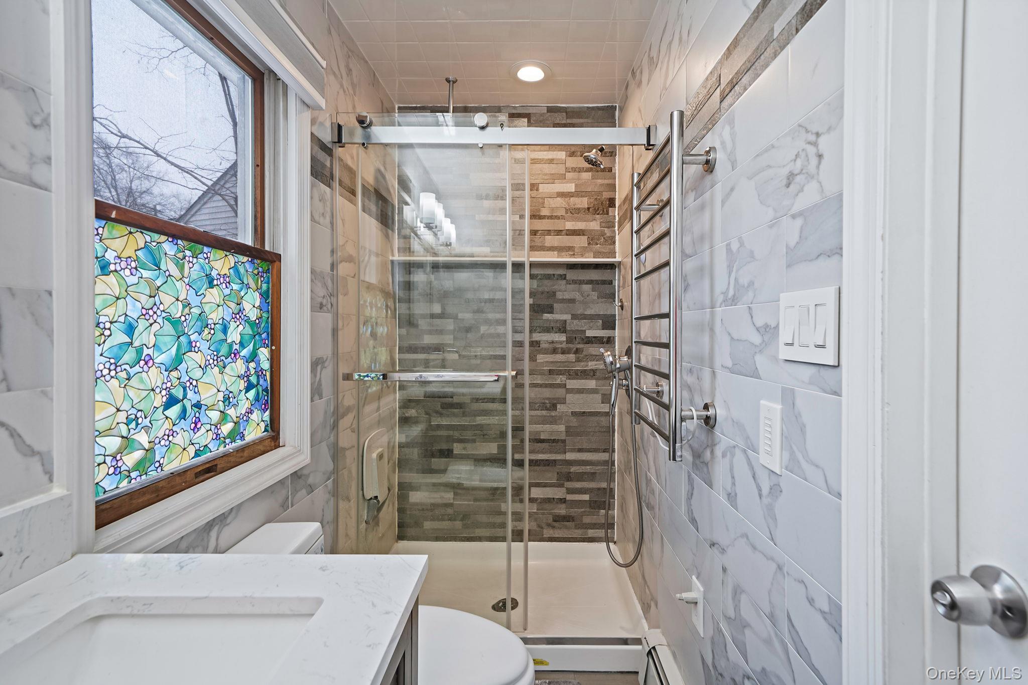 11 Nehring Avenue Babylon, NY 11702 - Photo 13 of 27 a bathroom with a shower toilet and sink