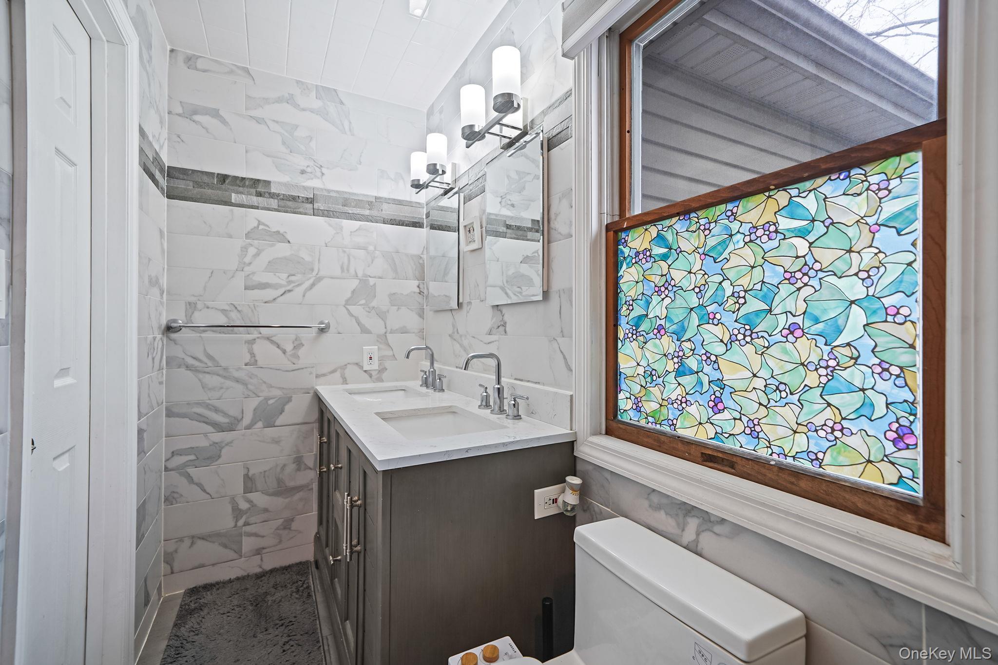 11 Nehring Avenue Babylon, NY 11702 - Photo 14 of 27 a bathroom with a sink and a mirror