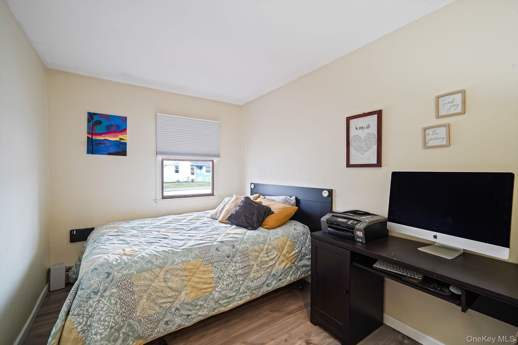 11 Nehring Avenue Babylon, NY 11702 - Photo 15 of 27 a bedroom with a bed and a laptop on the desk