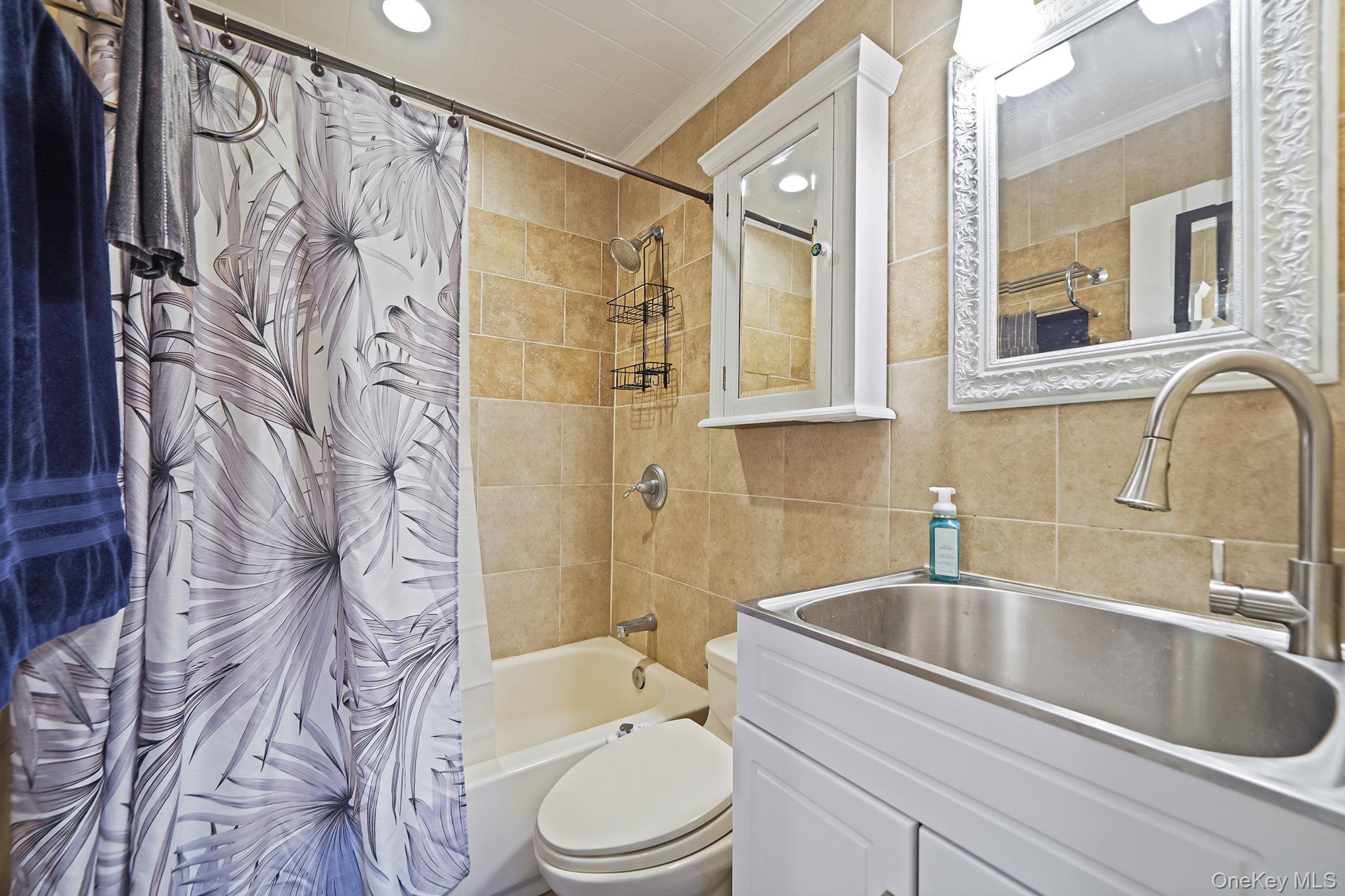 11 Nehring Avenue Babylon, NY 11702 - Photo 19 of 27 a bathroom with a sink a toilet and shower
