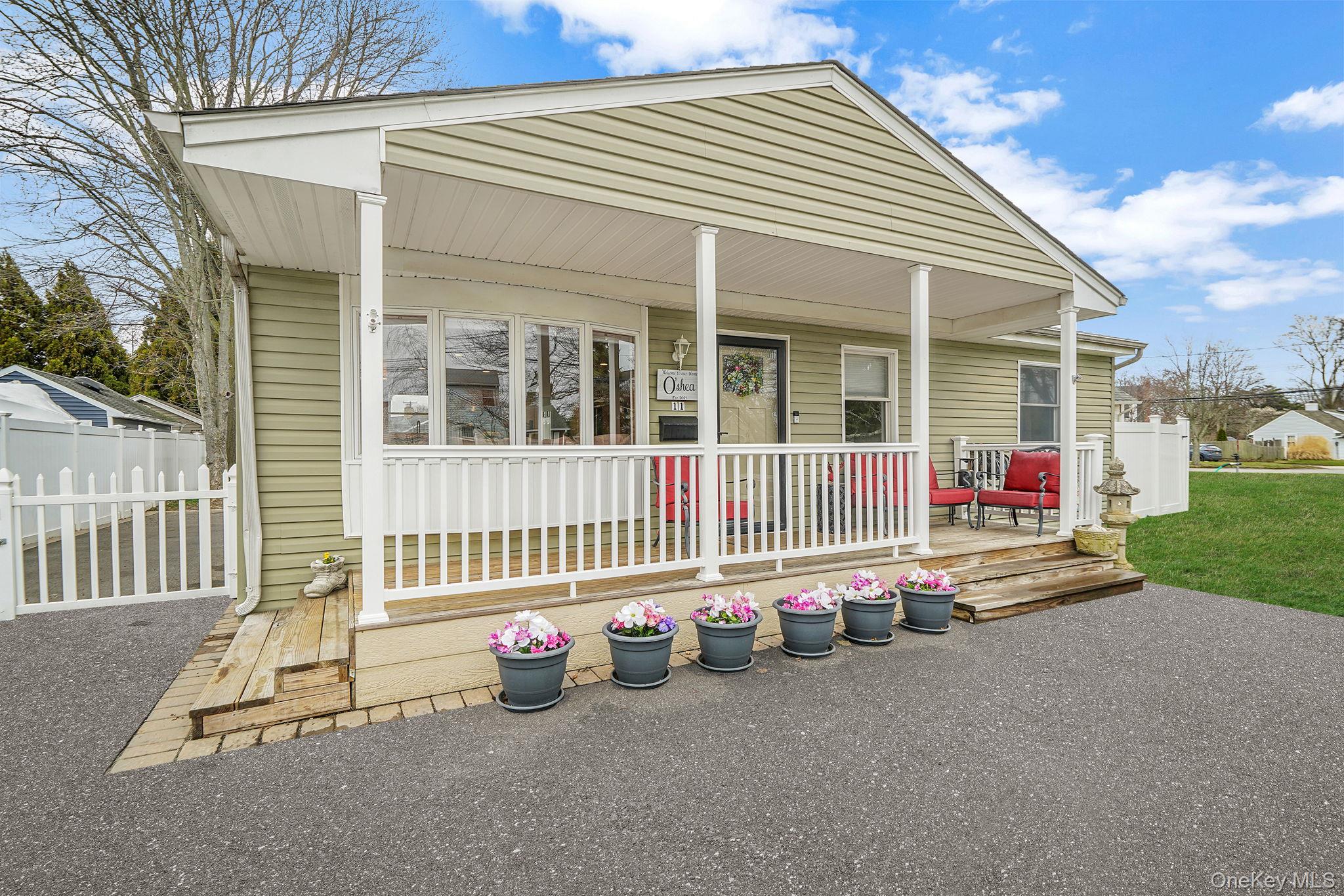 11 Nehring Avenue Babylon, NY 11702 - Photo 2 of 27 front view of a house with a porch