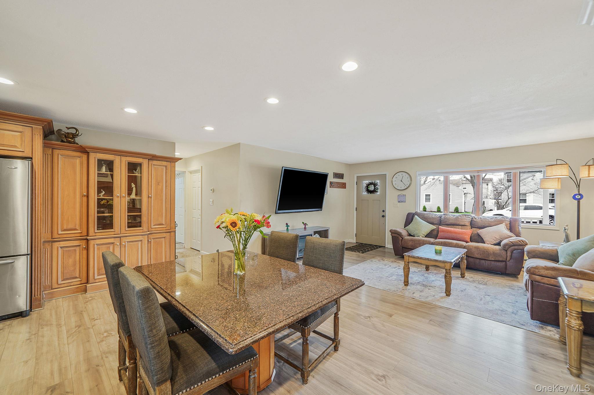 11 Nehring Avenue Babylon, NY 11702 - Photo 7 of 27 a living room with furniture wooden floor and a flat screen tv