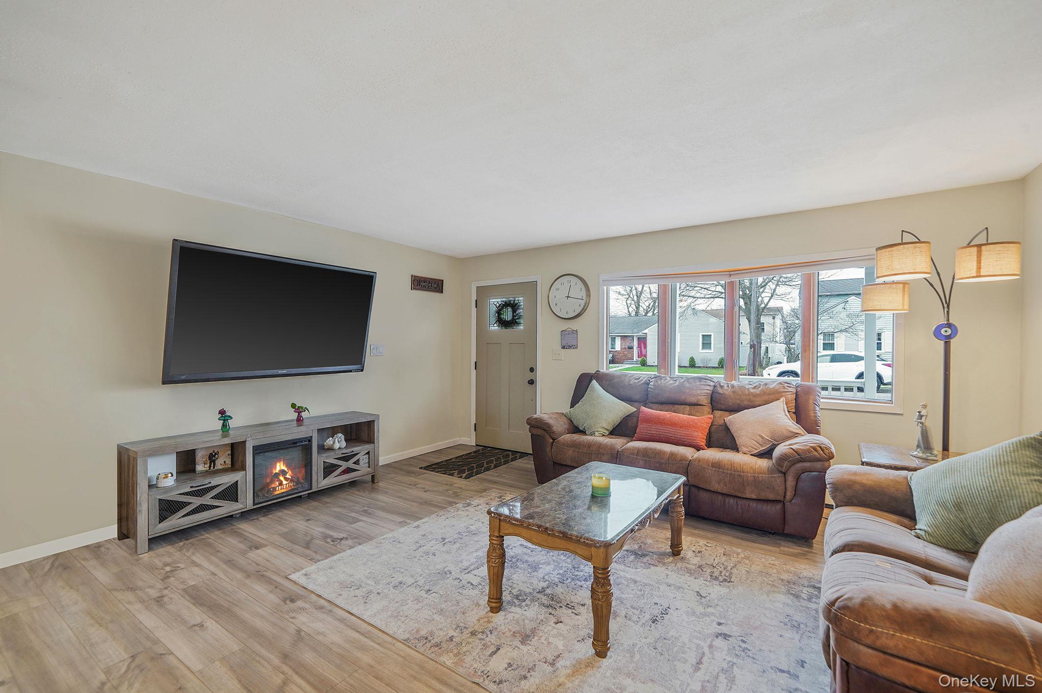 11 Nehring Avenue Babylon, NY 11702 - Photo 9 of 27 a living room with furniture and a flat screen tv