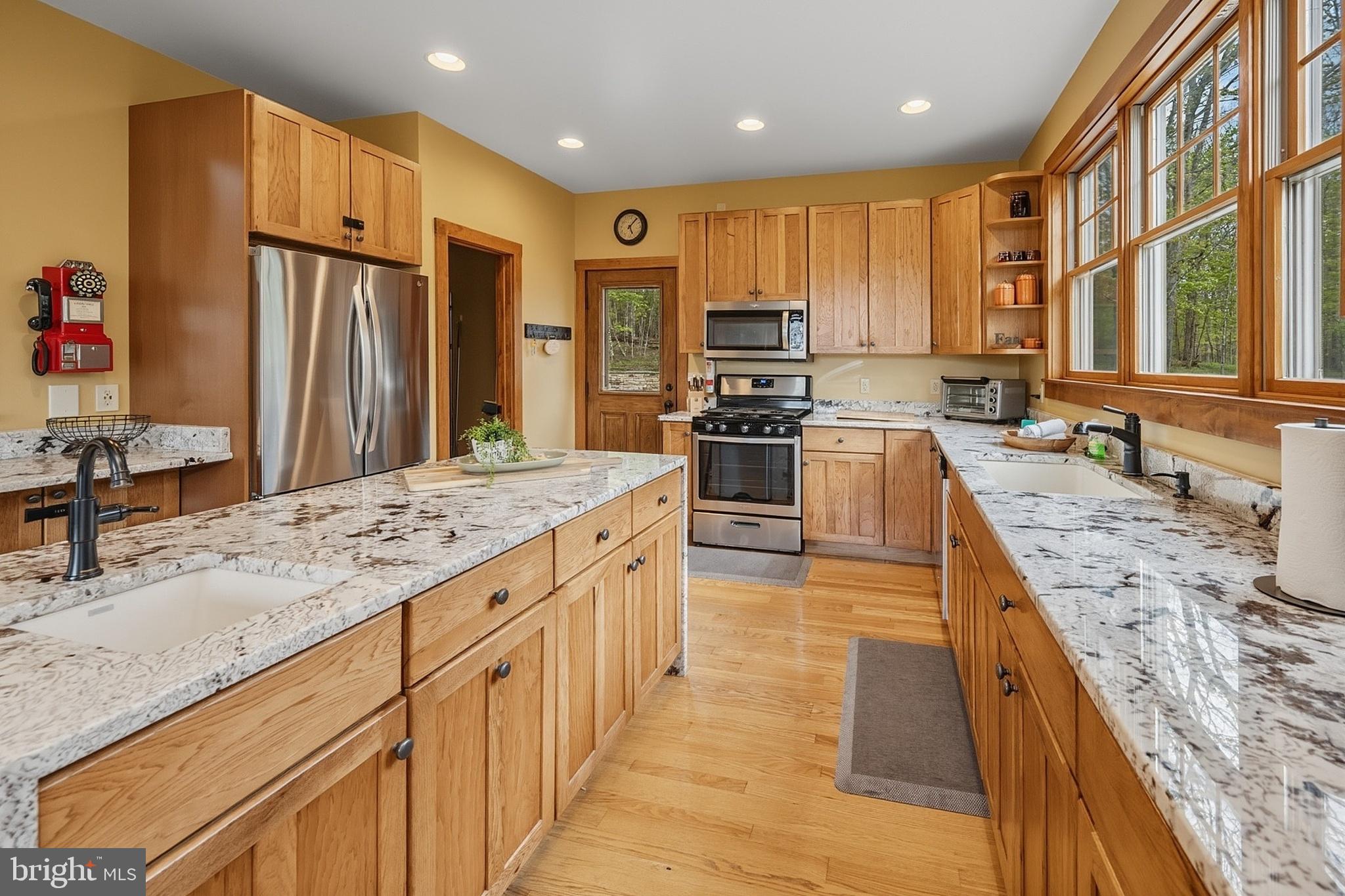 185 Ruta Lane Swanton, MD 21561 - Photo 18 of 81 a large kitchen with kitchen island granite countertop a sink stove and refrigerator