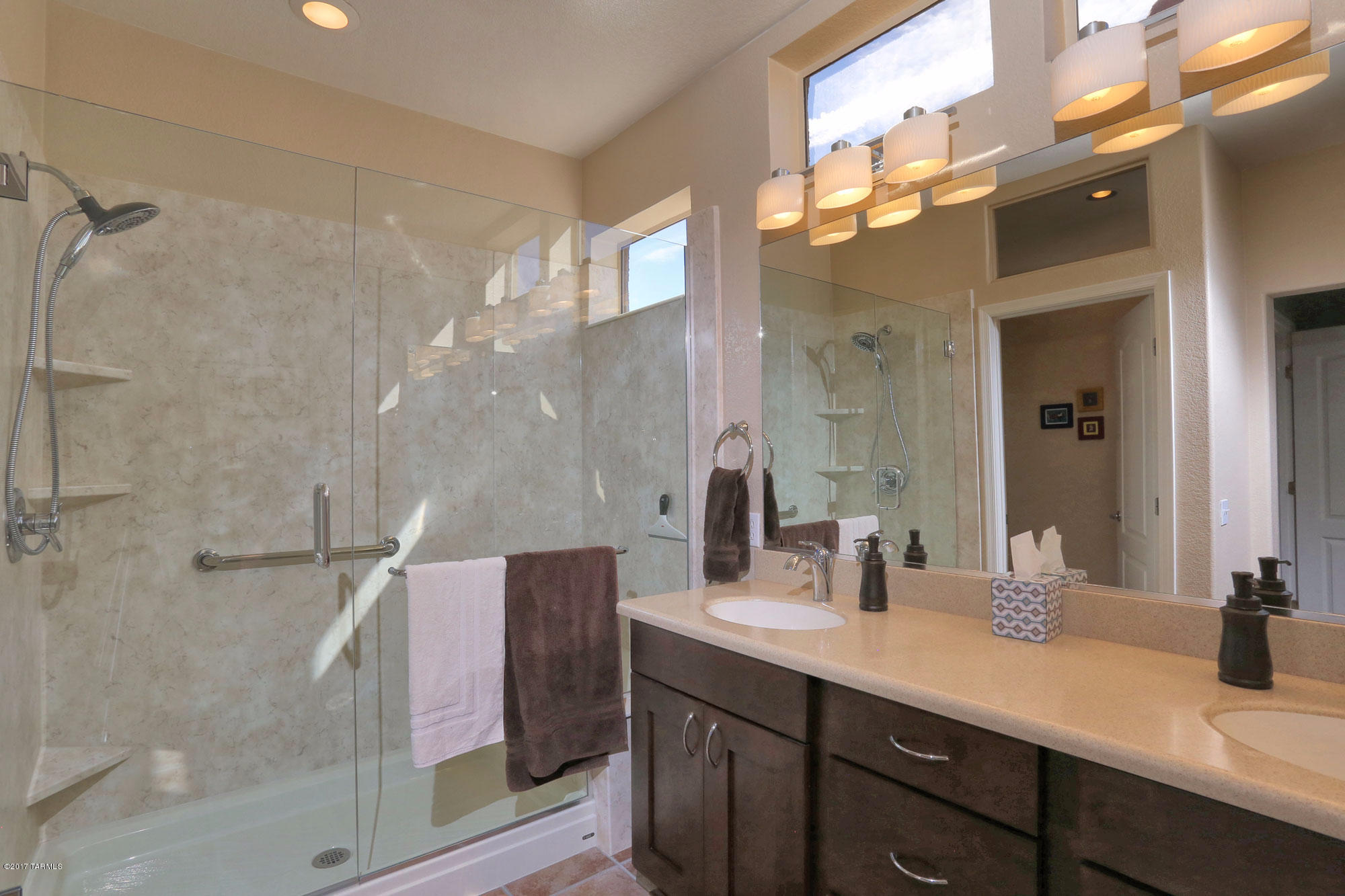 1065 East Royal Oak Road Oro Valley, AZ 85755 - Photo 13 of 19 a bathroom with a double vanity sink mirror and shower