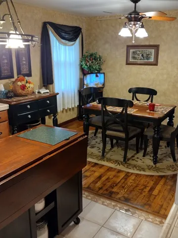 a bedroom with a bed and a lamp on dresser