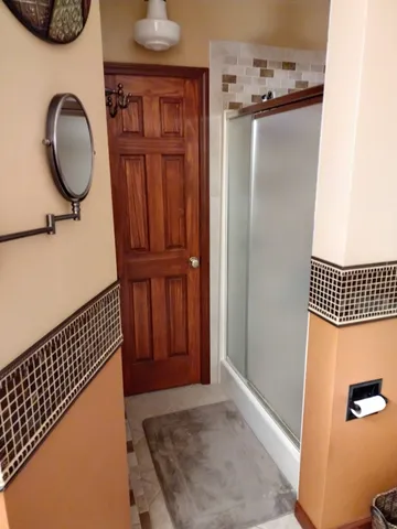 a bathroom with a toilet a sink and a mirror