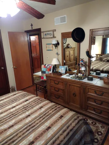 a view of backyard with a table and chairs and potted plants