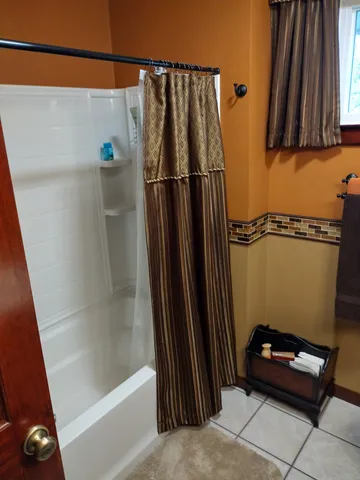 a view of a backyard with a table and chairs under an umbrella