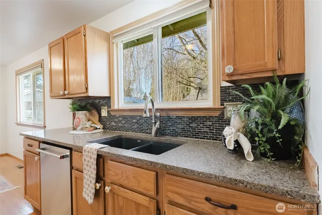 a kitchen with a sink a window and potted plant