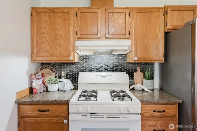 a kitchen with appliances cabinets and a counter top space
