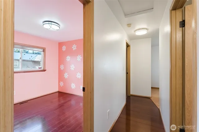 a view of a hallway with wooden floor