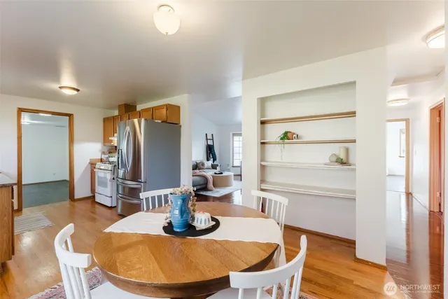 a dining room with furniture and wooden floor