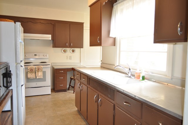 1709 Upper River Road Macon, GA 31211 - Photo 6 of 34 a kitchen with a sink stove and cabinets