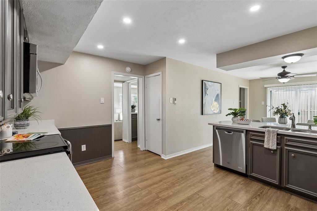 4962 Thunder Road Dallas, TX 75244 - Photo 7 of 26 Kitchen featuring wood-finish flooring, recessed lighting, and a kitchen peninsula with quartz countertops and an undermount sink