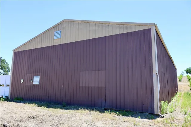 a view of a patio with table and chairs potted plants and palm tree