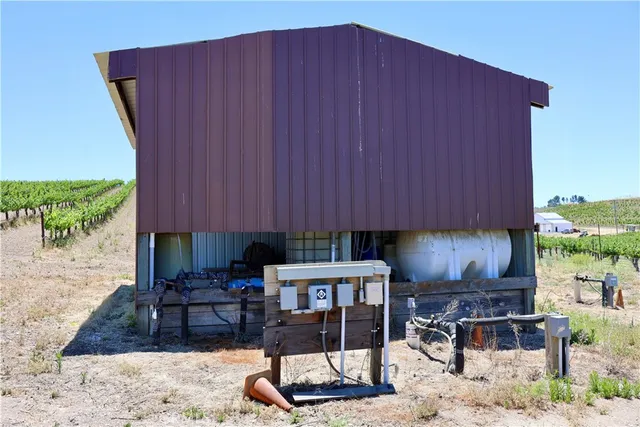 a view of a house with a yard and a tree