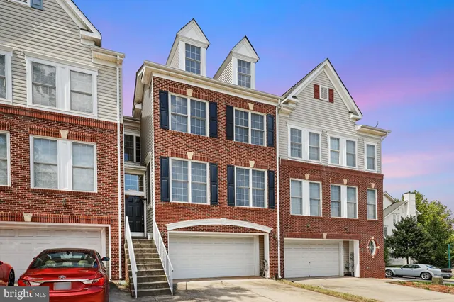 a front view of a residential apartment building with a yard