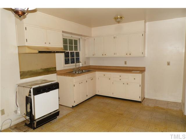 2909 Gladstone Drive Raleigh, NC 27610 - Photo 4 of 10 a view of a kitchen with white cabinets