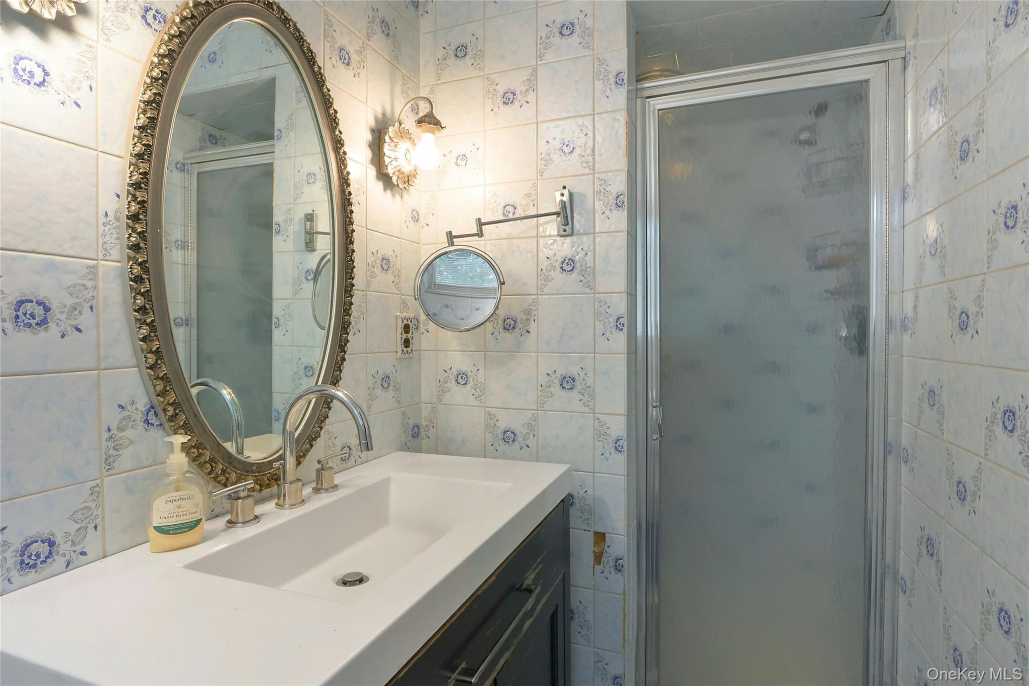 8 Windmill Lane New City, NY 10956 - Photo 20 of 33 a bathroom with a sink mirror and shower