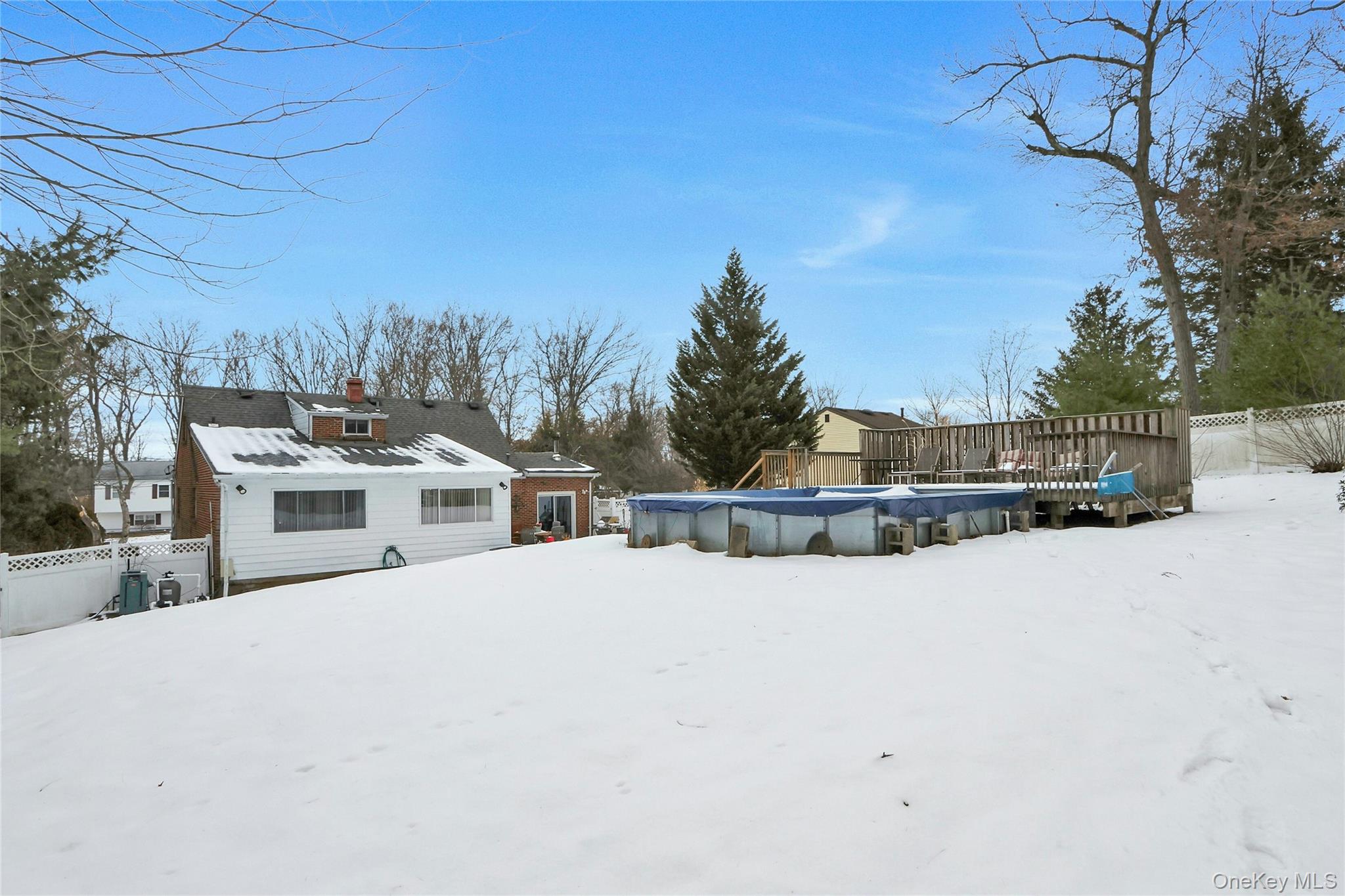 8 Windmill Lane New City, NY 10956 - Photo 28 of 33 a front view of a house with a yard covered in snow