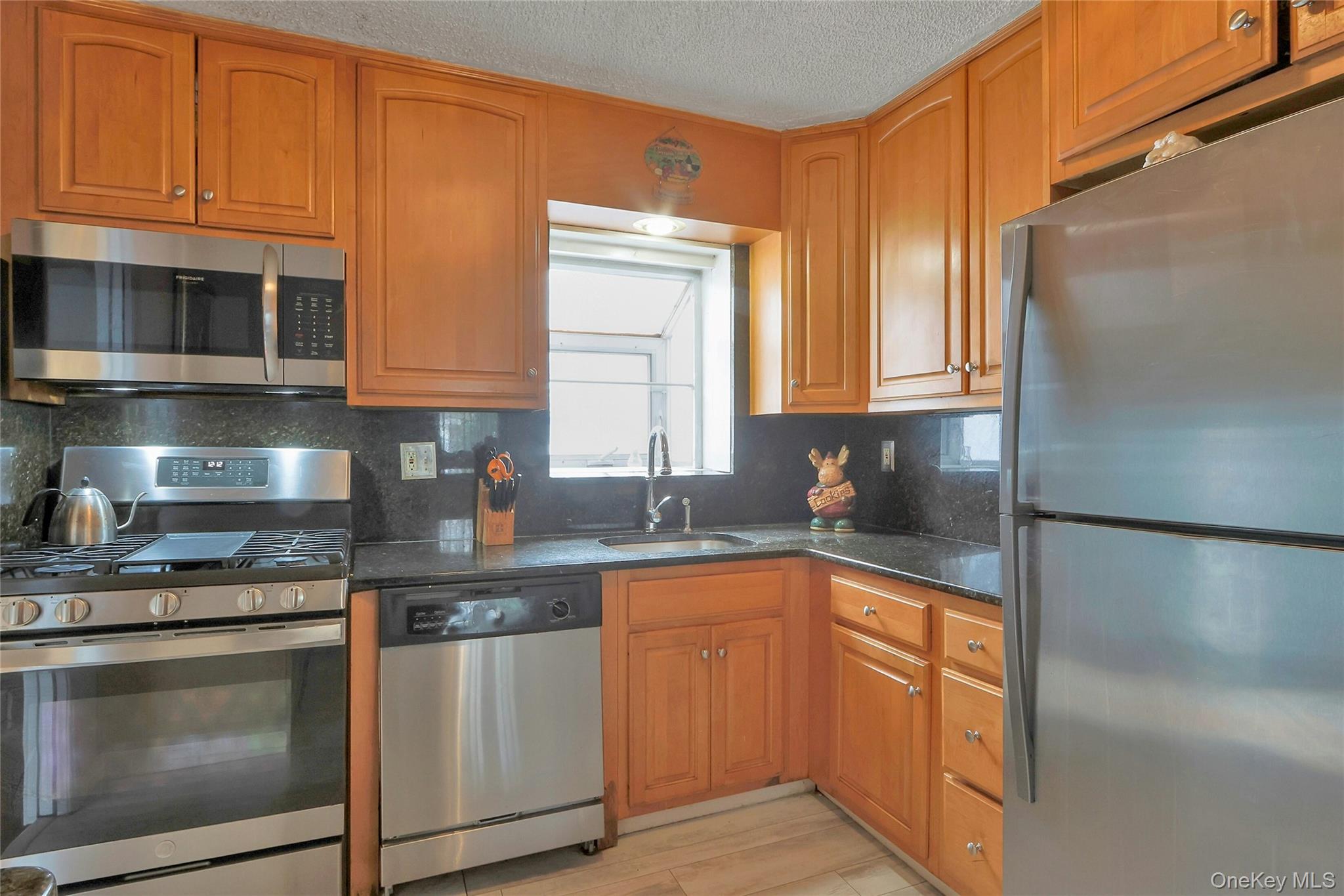 8 Windmill Lane New City, NY 10956 - Photo 4 of 33 a kitchen with stainless steel appliances granite countertop a sink a stove and a refrigerator