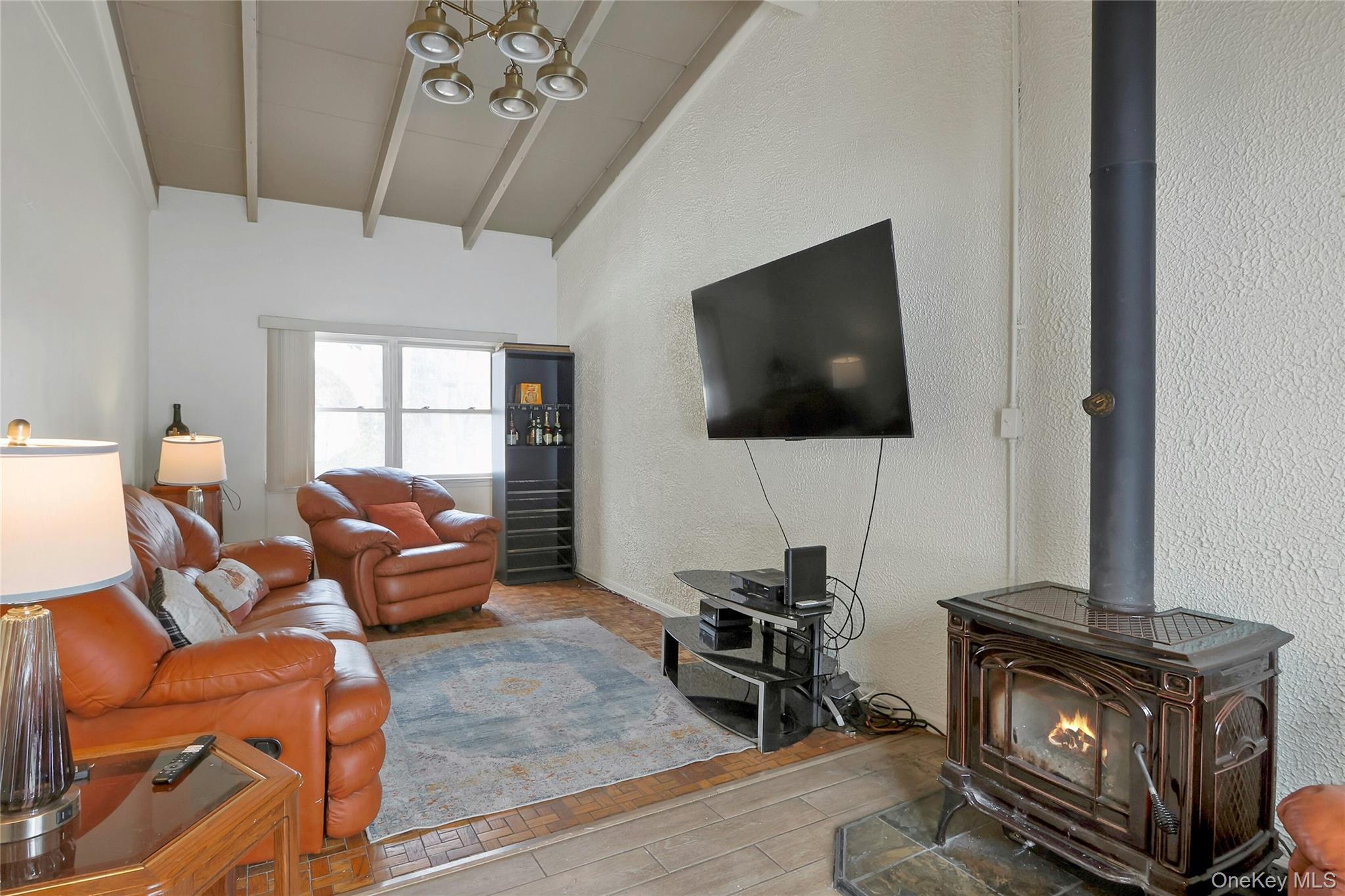 8 Windmill Lane New City, NY 10956 - Photo 9 of 33 a living room with furniture a flat screen tv and a chandelier