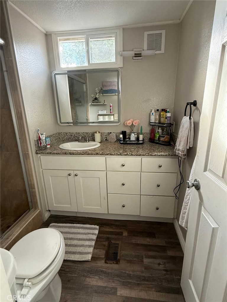 1350 San Bernardino Road, Unit 144 Upland, CA 91786 - Photo 11 of 17 a bathroom with a sink a toilet a mirror and window