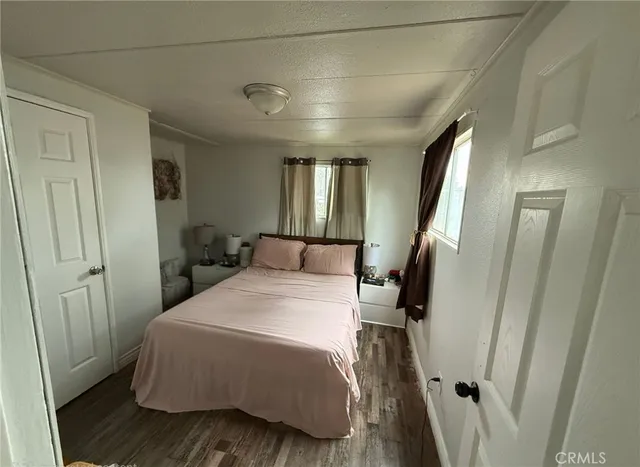 a bedroom with a bed and a large mirror