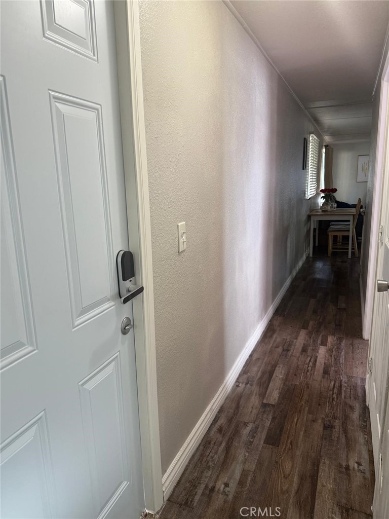 1350 San Bernardino Road, Unit 144 Upland, CA 91786 - Photo 13 of 17 a view of a hallway with wooden floor and a living room