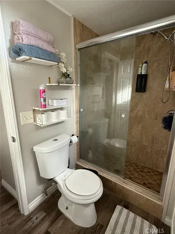 a bathroom with a toilet and a shower