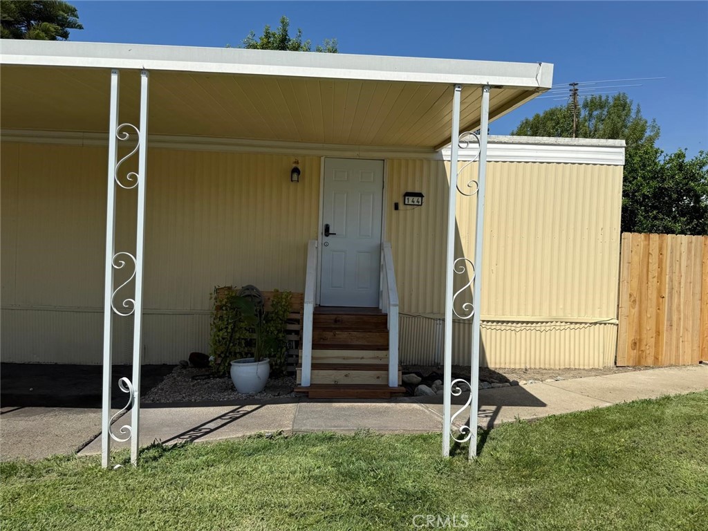 1350 San Bernardino Road, Unit 144 Upland, CA 91786 - Photo 3 of 17 a backyard of a house with plants and wooden fence