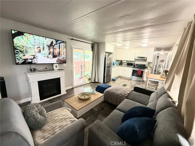 a living room with furniture fireplace and large windows