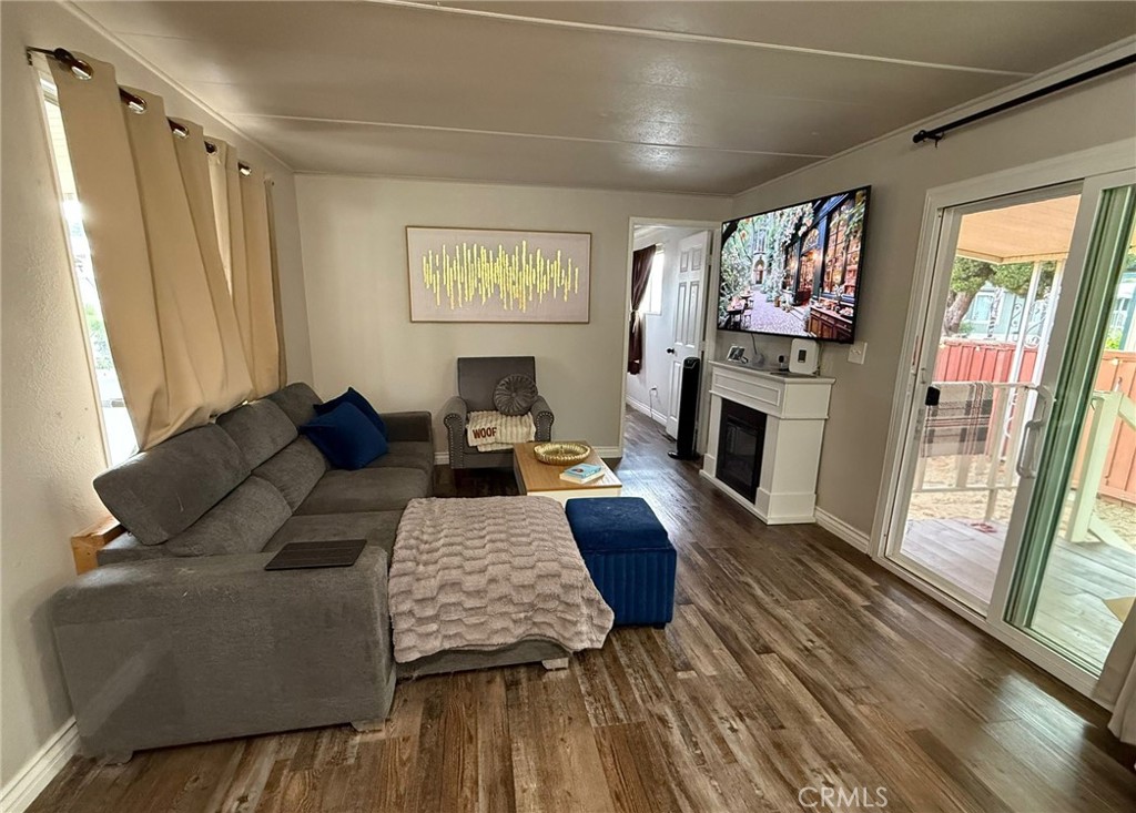 1350 San Bernardino Road, Unit 144 Upland, CA 91786 - Photo 8 of 17 a living room with furniture and a flat screen tv