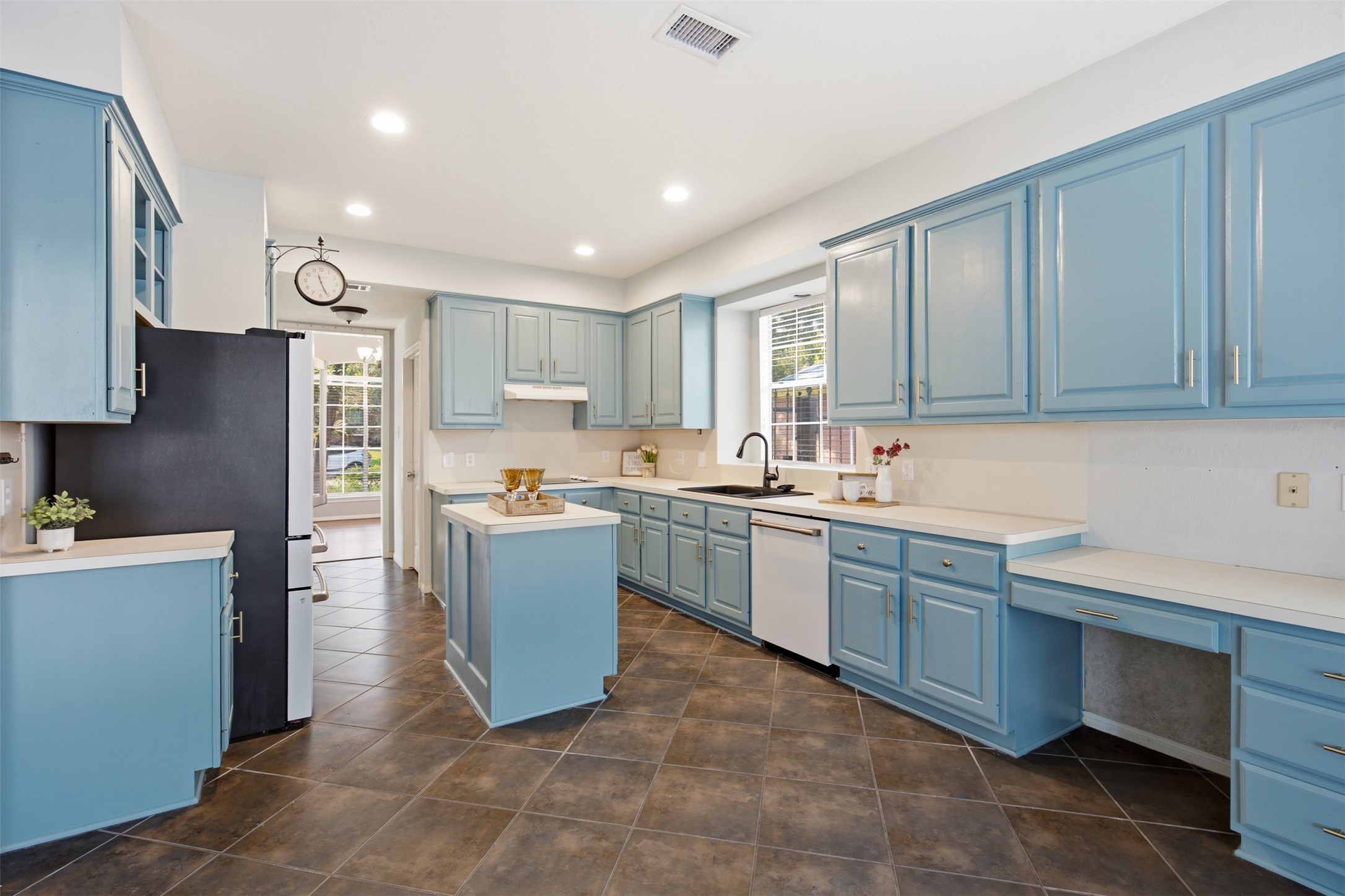 323 Magic Oaks Court Spring, TX 77388 - Photo 12 of 49 Here you can see the thoughtfully designed kitchen, including a built-in desk ready to become your central home organization station.