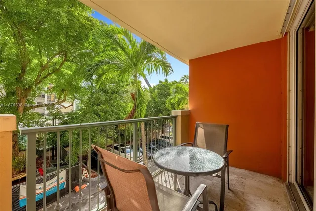 a balcony with a table and chairs