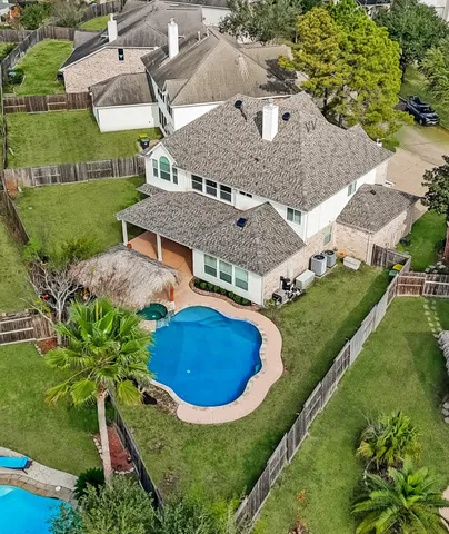 an aerial view of residential house with outdoor space and pool