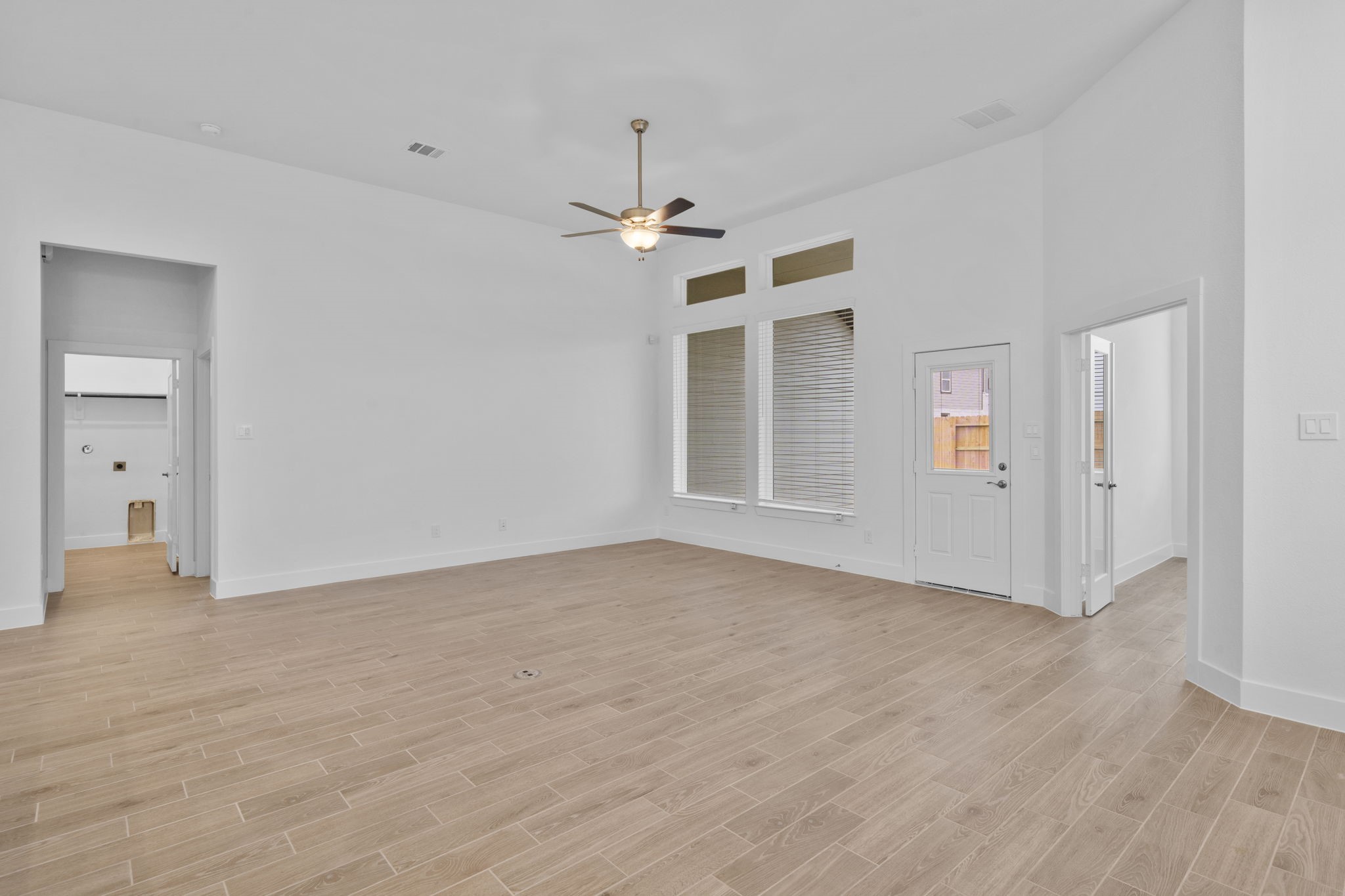 337 Gambels Quail Road Waller, TX 77484 - Photo 11 of 35 an empty room with wooden floor ceiling fan and windows