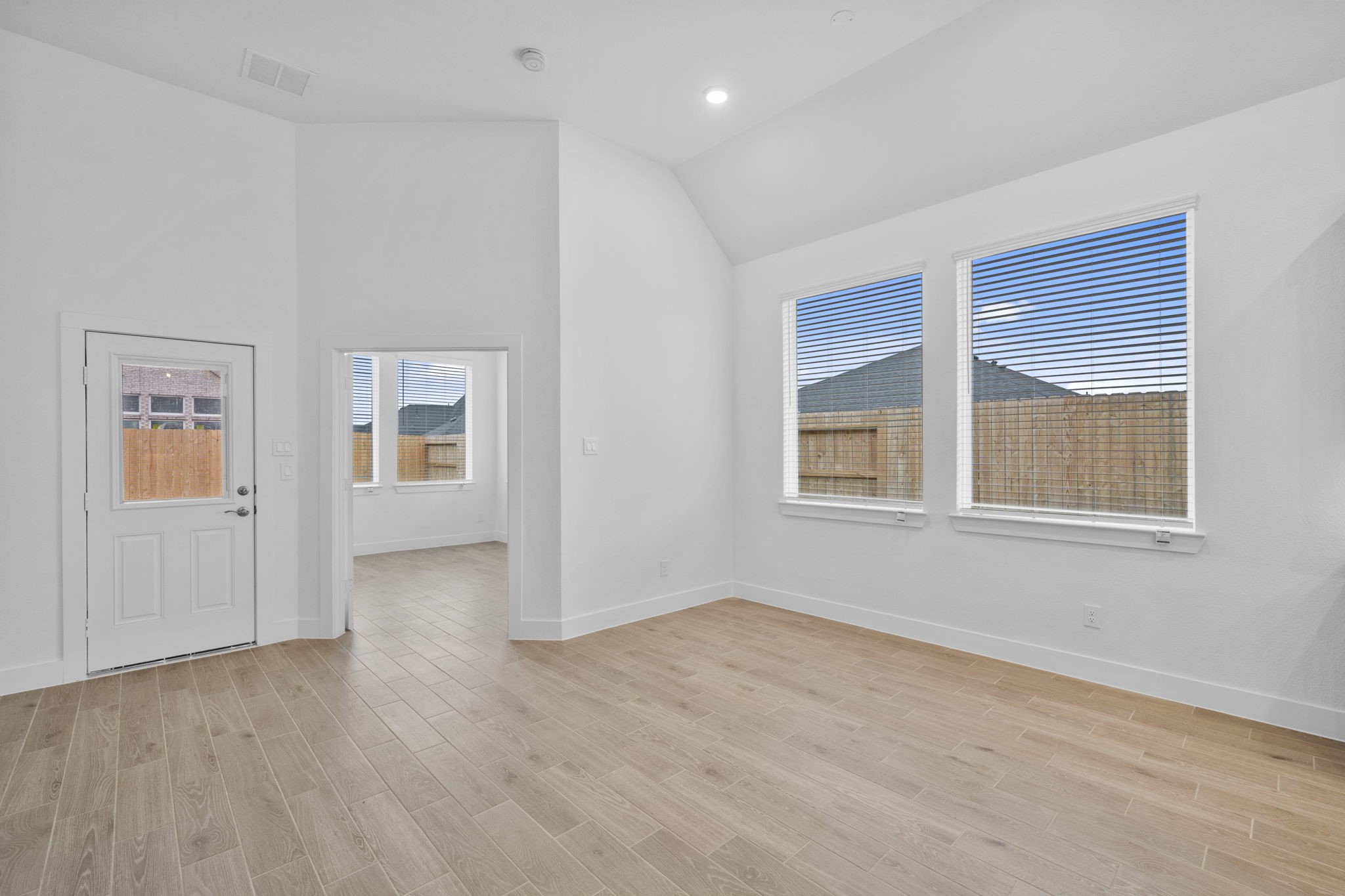 337 Gambels Quail Road Waller, TX 77484 - Photo 12 of 35 a view of an empty room with wooden floor and a window