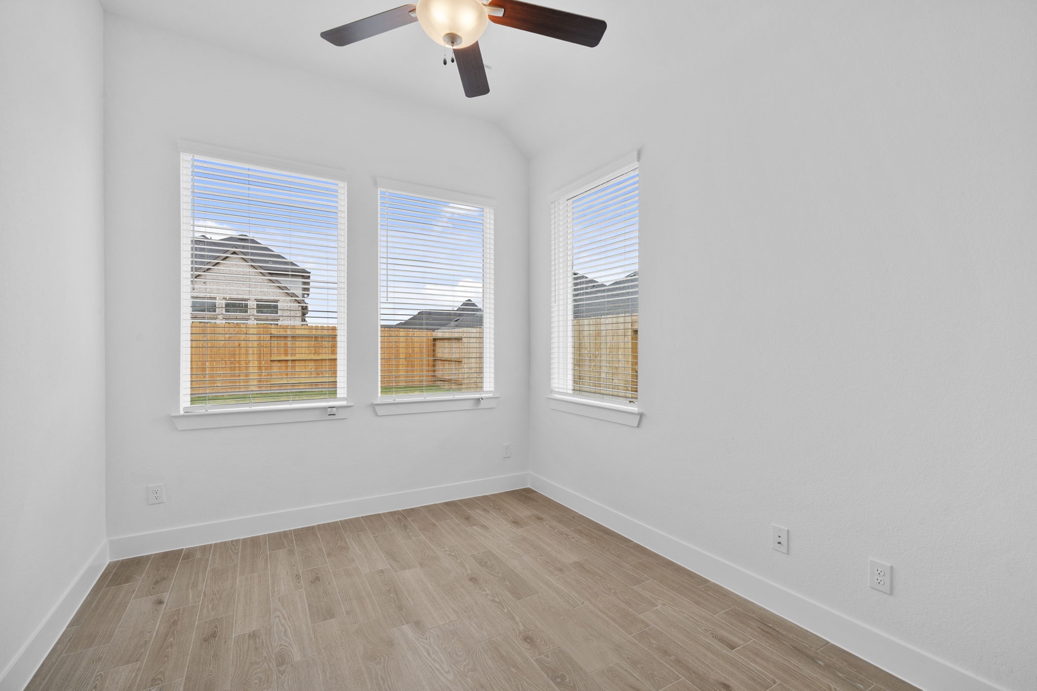337 Gambels Quail Road Waller, TX 77484 - Photo 18 of 35 a view of an empty room with a window and wooden floor